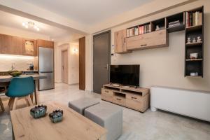 a living room with a television and a couch and a table at Al Centro Zante city flat in Zakynthos