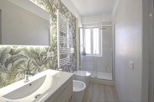 a bathroom with a sink and a toilet and a shower at Casetta Tuscolana in Rome +16 photos