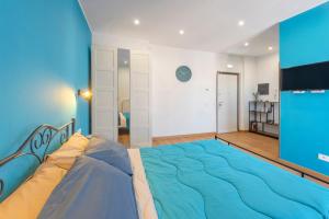 a bedroom with a large bed with blue sheets at Casetta Tuscolana in Rome