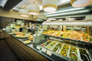 a buffet line with a lot of food at Hotel Europa Fit Hévíz in Hévíz