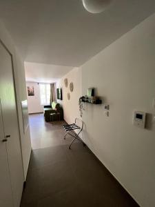 a living room with white walls and a couch at SOUS LES PLATANES in Velaux