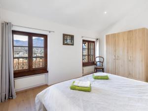 a bedroom with a bed with two green towels on it at Holiday Home Casa Dumont by Interhome in Manno