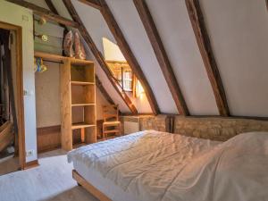 a bedroom with a bed in a attic at Holiday Home Le Moulin by Interhome in Fons