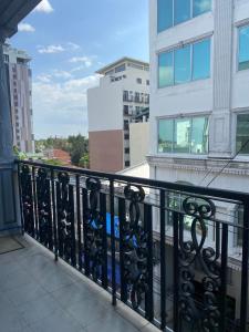 a balcony with a black railing and buildings at ROVIMAR in Angeles