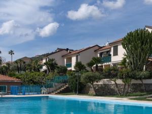 a villa with a swimming pool and houses at Apartment Rosy by Interhome in Costarainera