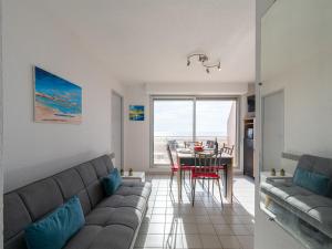 a living room with a couch and a table at Apartment Les Terrasses du Levant by Interhome in Narbonne-Plage