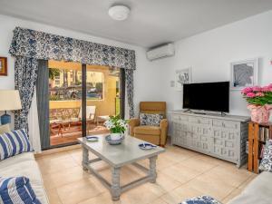 a living room with a television and a table at Apartment Dona Lola by Interhome in Sitio de Calahonda