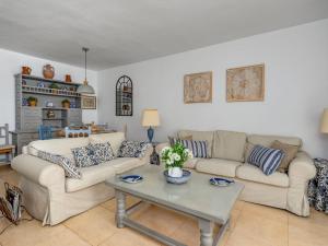a living room with two couches and a table at Apartment Dona Lola by Interhome in Sitio de Calahonda +47 photos