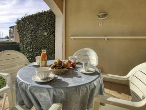 a table with a bowl of fruit on it at Apartment Les Rivages de Coudoulière-8 by Interhome in Six-Fours-les-Plages