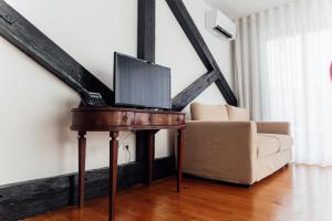 a living room with a table with a laptop on it at 54 São Paulo - Exclusive Apartment Hotel in Lisbon