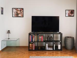 A television and/or entertainment centre at Apartment Vasco de Gama B11-R by Interhome