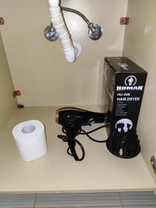 a bathroom counter with a box and a roll of toilet paper at Δροσια 1 in Nafplio +101 photos