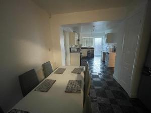 a kitchen and dining room with a table and chairs at Crompton Haven, Liverpool Accessible Home in Liverpool