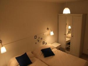 a bedroom with two beds and a mirror and lights at Hochwertige Ferienwohnung im Grüngürtel der Stadt in Madrid