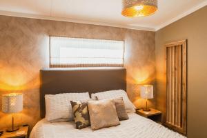 a bedroom with a white bed with two lamps at St Helens 2-Bed Lodge Sleeps 4 Pets Ok & Pool in Saint Helens +28 photos