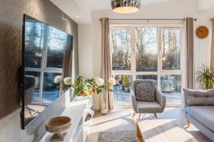 a living room with a couch and a tv at St Helens 2-Bed Lodge Sleeps 4 Pets Ok & Pool in Saint Helens