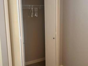 a closet with a mirror and a door with at Private Basement Suite with comfort in Winnipeg