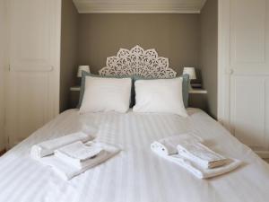 ein weißes Bett mit zwei Handtüchern darüber in der Unterkunft Holiday Home Le Mas Saphir by Interhome in Bouveret