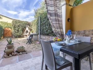 eine Terrasse mit einem schwarzen Tisch und Stühlen in der Unterkunft Apartment Happy Island by Interhome in Badesi