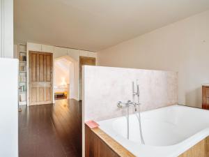 a large white bath tub in a room at Villa Scarlette by Interhome in Saint-Briac-sur-Mer