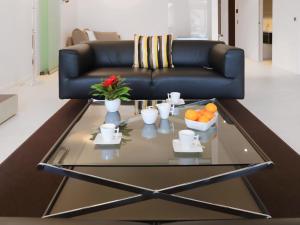 a living room with a black couch and a coffee table at Apartment Les Terrasses C1-7 by Interhome in Montreux