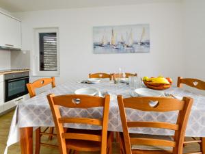un comedor con una mesa con sillas y un bol de plátanos en Apartment Sanja-2 by Interhome, en Novi Vinodolski 25 fotos más