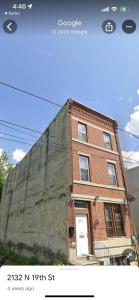 a large brick building with at A bedroom with a shared full bathroom in Philadelphia