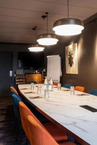 a long table in a room with chairs and lights at Oceania Le Conti in Brest