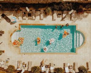 an overhead view of a swimming pool with people in it at Tenuta Mocajo in Guardistallo