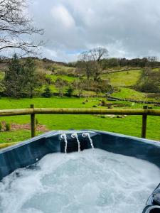 a hot tub with water coming out of it at Lavender Retreat with Private Hot Tub in Upper Hulme