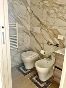 a bathroom with a white toilet and a sink at B&B Nadia House in Bisceglie