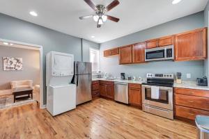 a kitchen with stainless steel appliances and wooden cabinets at Central St Louis apartment 1W in Soulard