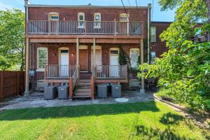 a brick house with a balcony on the front of it at Central St Louis apartment 1W in Soulard