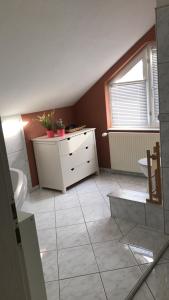 a bathroom with a sink and a toilet and a window at Ferienwohnung Mandelblüte in Schotten