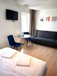 a room with a bed and a table and a couch at 3 Budget Stay Apartments in Zgorzelec