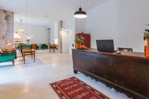 a living room with a desk with a laptop on it at 2nd Station Hostel in Bled