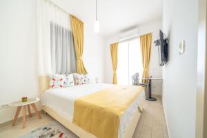 a bedroom with a large bed with a yellow blanket at Mariner Apartments in Sutomore