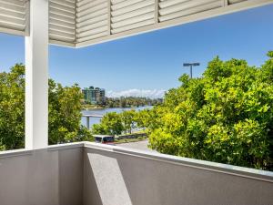 a balcony with a view of a street and trees at Spacious 3BR Retreat w Lake view Varsity Lakes in Gold Coast