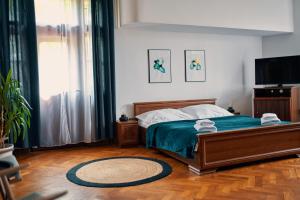 a bedroom with a bed and a flat screen tv at Penzion Pivovar Volt in Jablonec nad Nisou