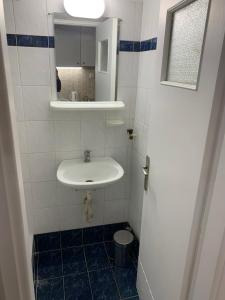 a small bathroom with a sink and a mirror at Omonoia Cozy Apartment Athens in Athens