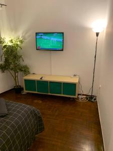 a living room with a television on a wall at Omonoia Cozy Apartment Athens in Athens