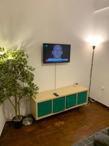 a living room with a tv on a wall at Omonoia Cozy Apartment Athens in Athens