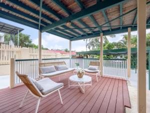 a patio with chairs and a table on a deck at Serene 3 Bedroom Inner City Retreat Highgate Hill in Brisbane