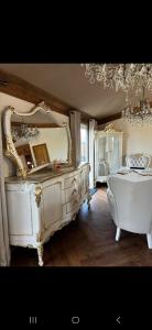 a white bedroom with a large mirror and a tub at Badgers rest lodge in Kinlet