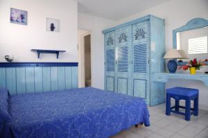 a bedroom with a blue bed and a blue cabinet at Résidence Tropicale in Le Moule