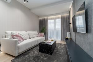 a living room with a white couch and a table at Premium House in Rzeszów
