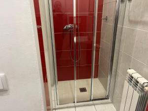 een douche met een glazen deur in de badkamer bij Casa de Casarelhos - T2 - Gerês in Geres