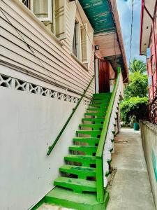 a set of green stairs leading to a house at SMITH'S HOMESTAY in Georgetown