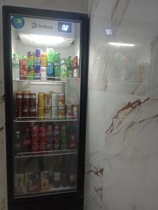 a refrigerator filled with lots of drinks at Hotel Endless Love in Carapicuíba