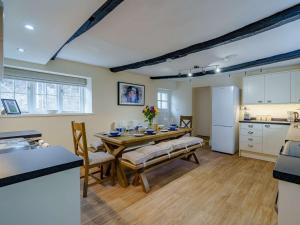 a kitchen and dining room with a table and a refrigerator at 3 Bed in Buttermere 82775 in Buttermere